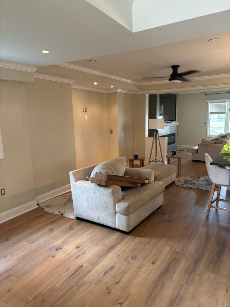 Open living room with freshly painted walls and new wood flooring